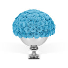 Bouquet of blue roses in a silver vase on a white background
