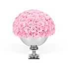 Pink roses in a silver vase on a white background