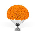 Bouquet of orange roses in a silver vase on a white background