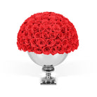 Bouquet of red roses in a silver vase on a white background