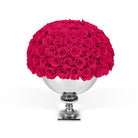 Bouquet of pink roses in a silver vase on a white background