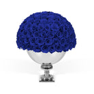 Bouquet of blue roses in a silver vase on a white background