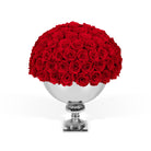 Bouquet of red roses in a silver vase on a white background