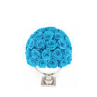 Blue roses in a white vase on a white background