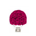 Bouquet of bright pink roses in a white vase on a white background