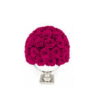 Bouquet of bright pink roses in a white vase on a white background