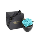 Black gift box with 'Only Roses' branding next to a black vase with blue roses on a white background