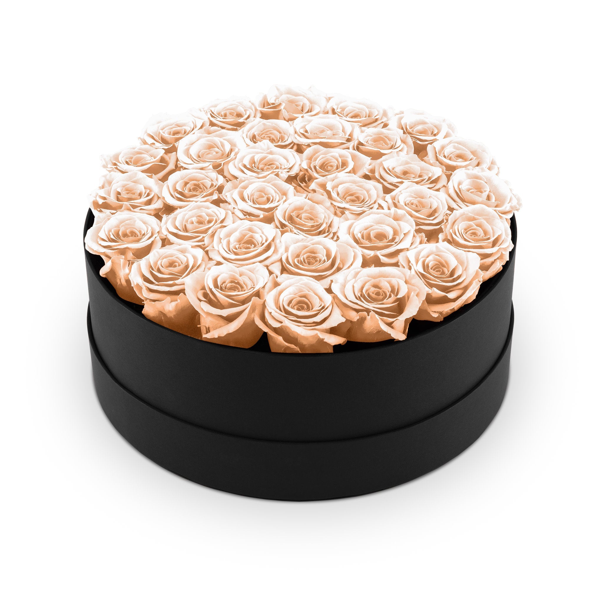 Round black box filled with peach roses on a white background