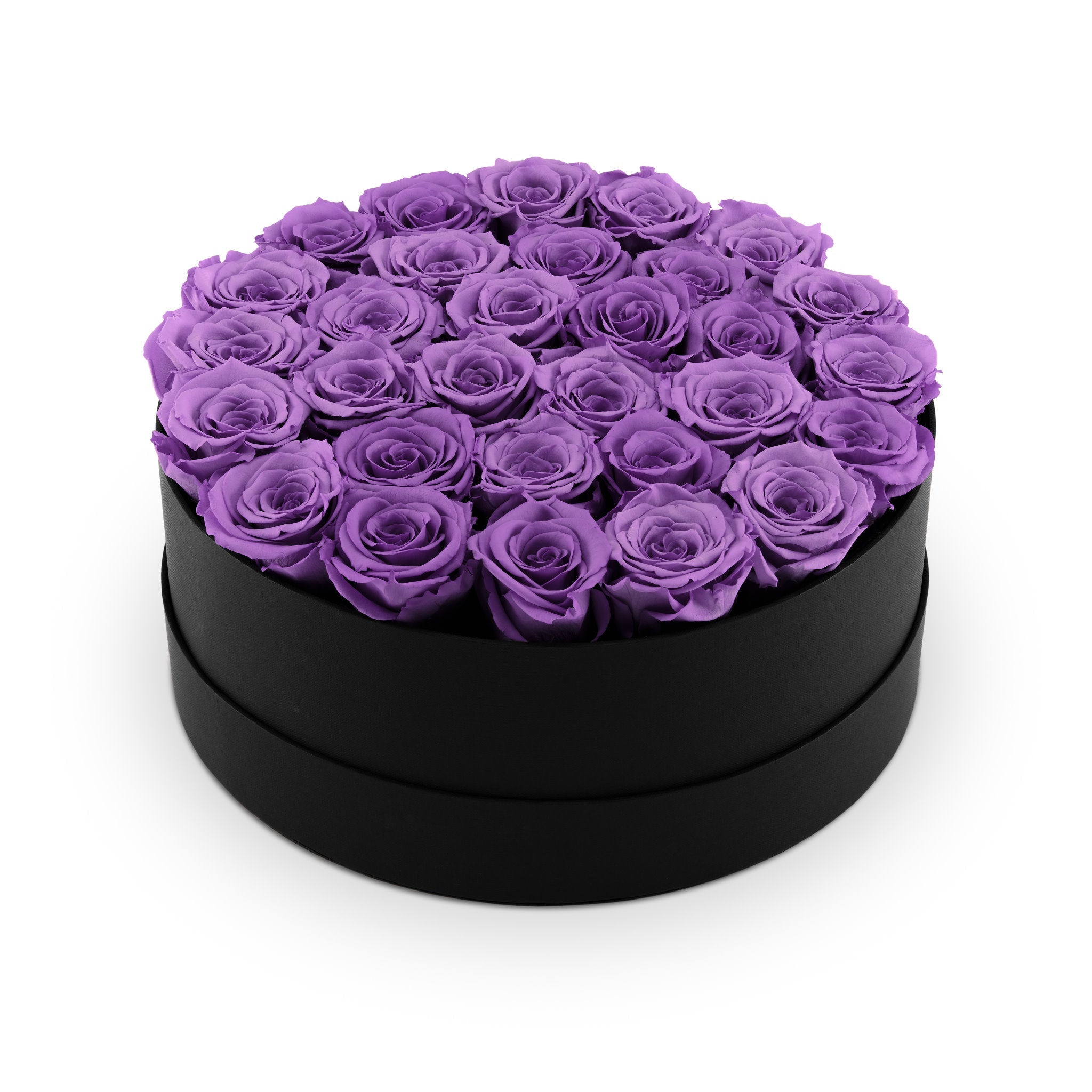 Black round box filled with purple roses on a white background