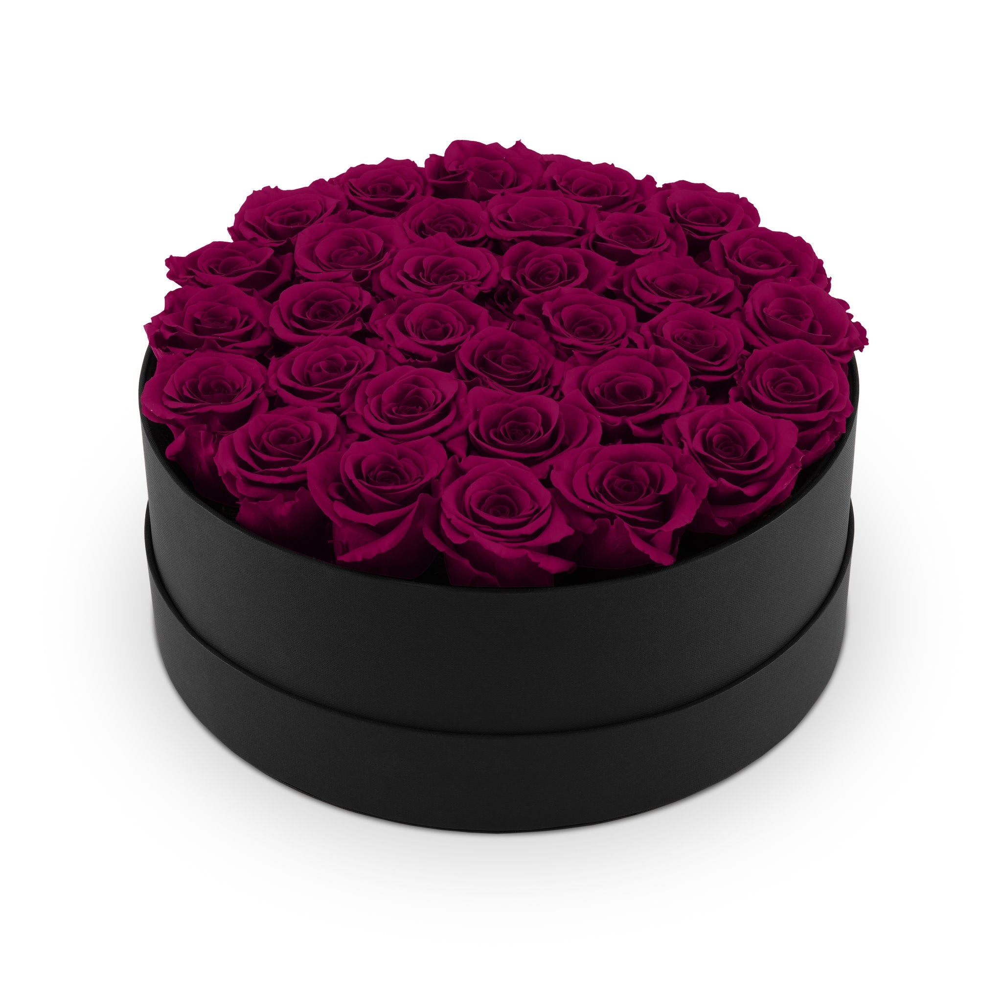 Black round box filled with purple roses on a white background