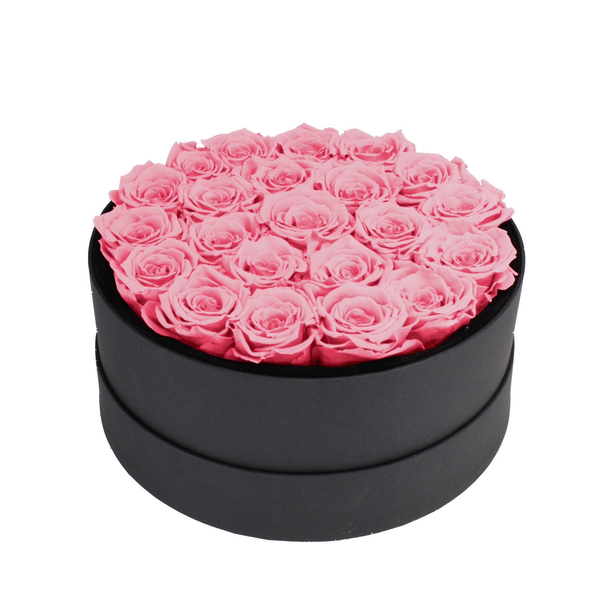 Black round box filled with pink roses on a white background