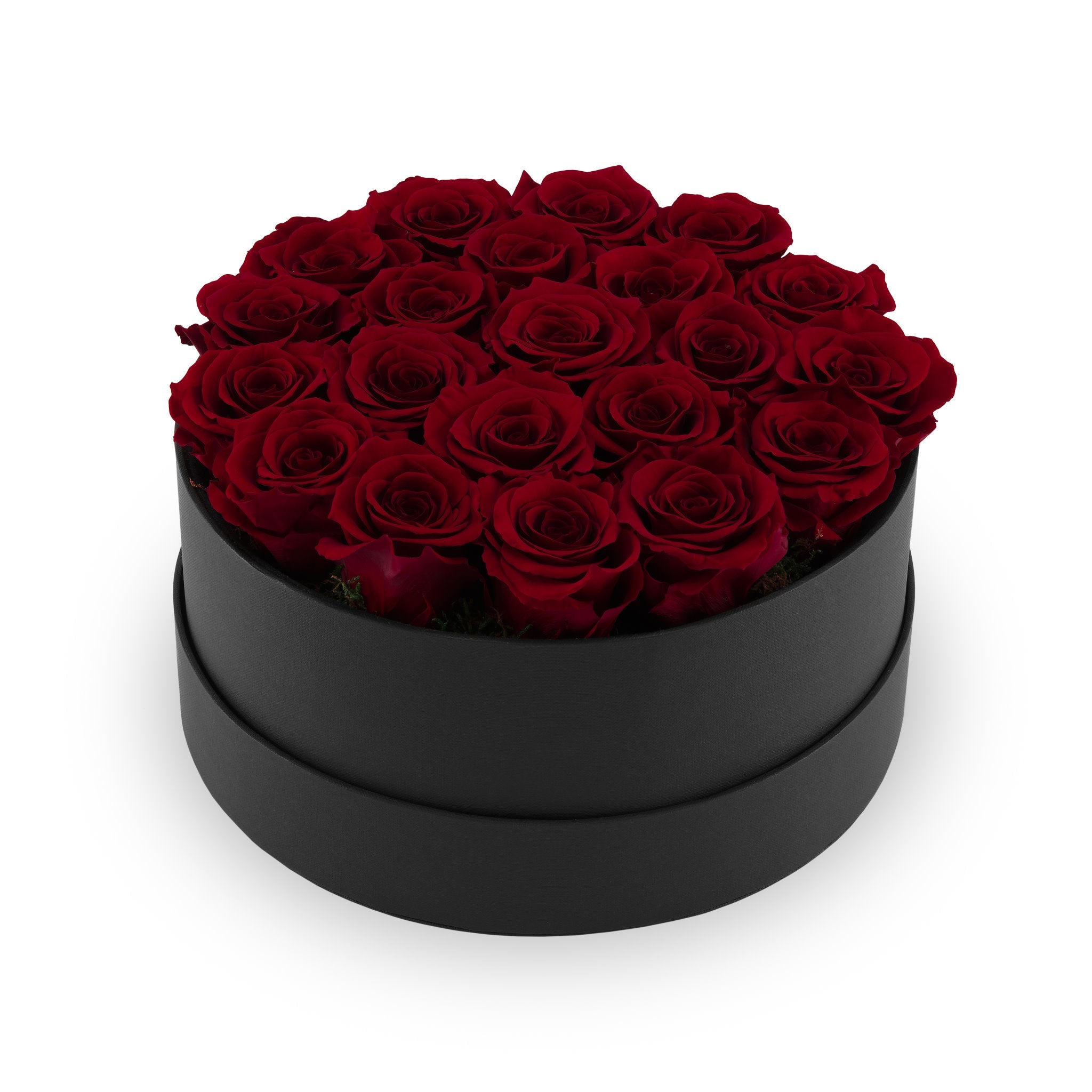 Black round box filled with red roses on a white background