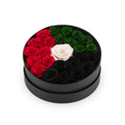 Round black box with red, green, and white roses on a white background