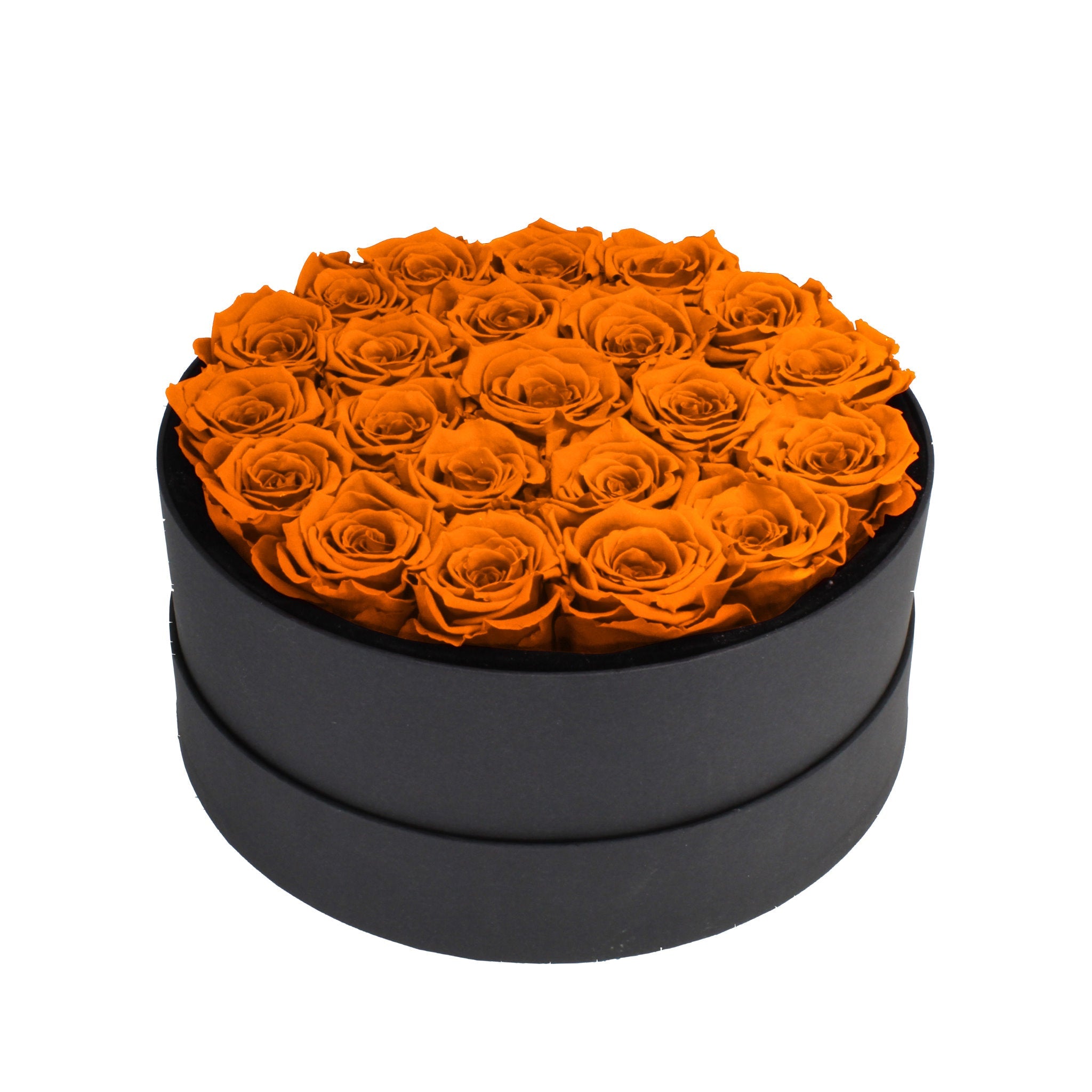 Black round box filled with orange roses on a white background