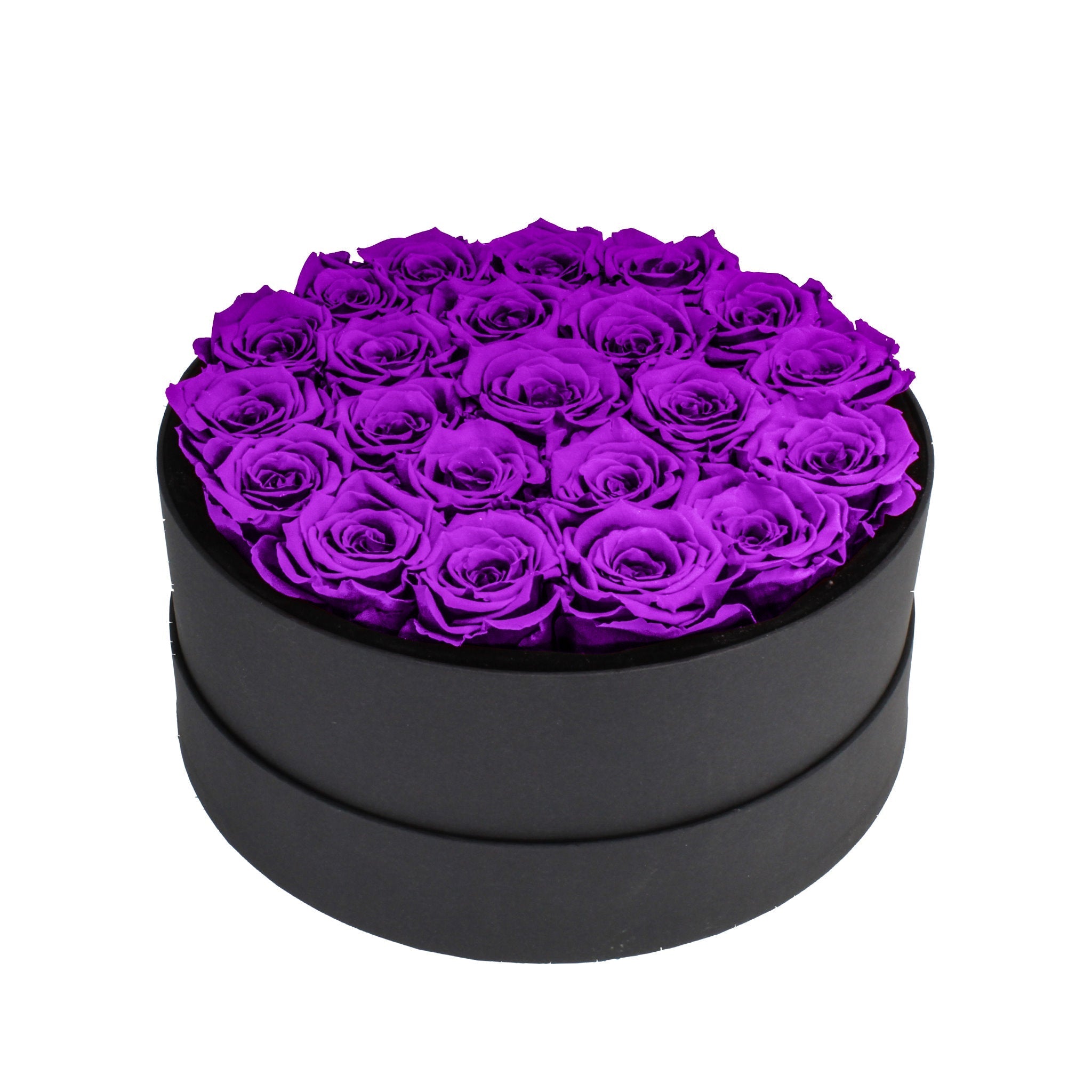 Black round box filled with purple roses on a white background