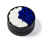 Round black box with white and blue roses on a white background
