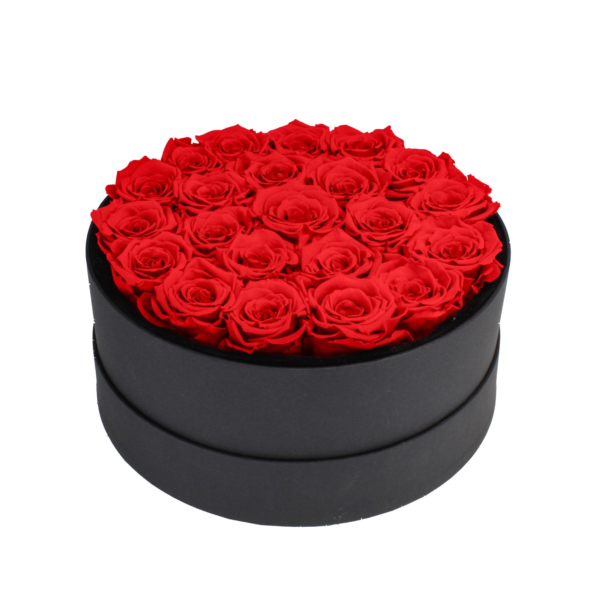 Black round box filled with red roses on a white background
