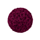 Round arrangement of dark red roses on a white background