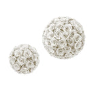 Two decorative spheres made of white roses on a white background