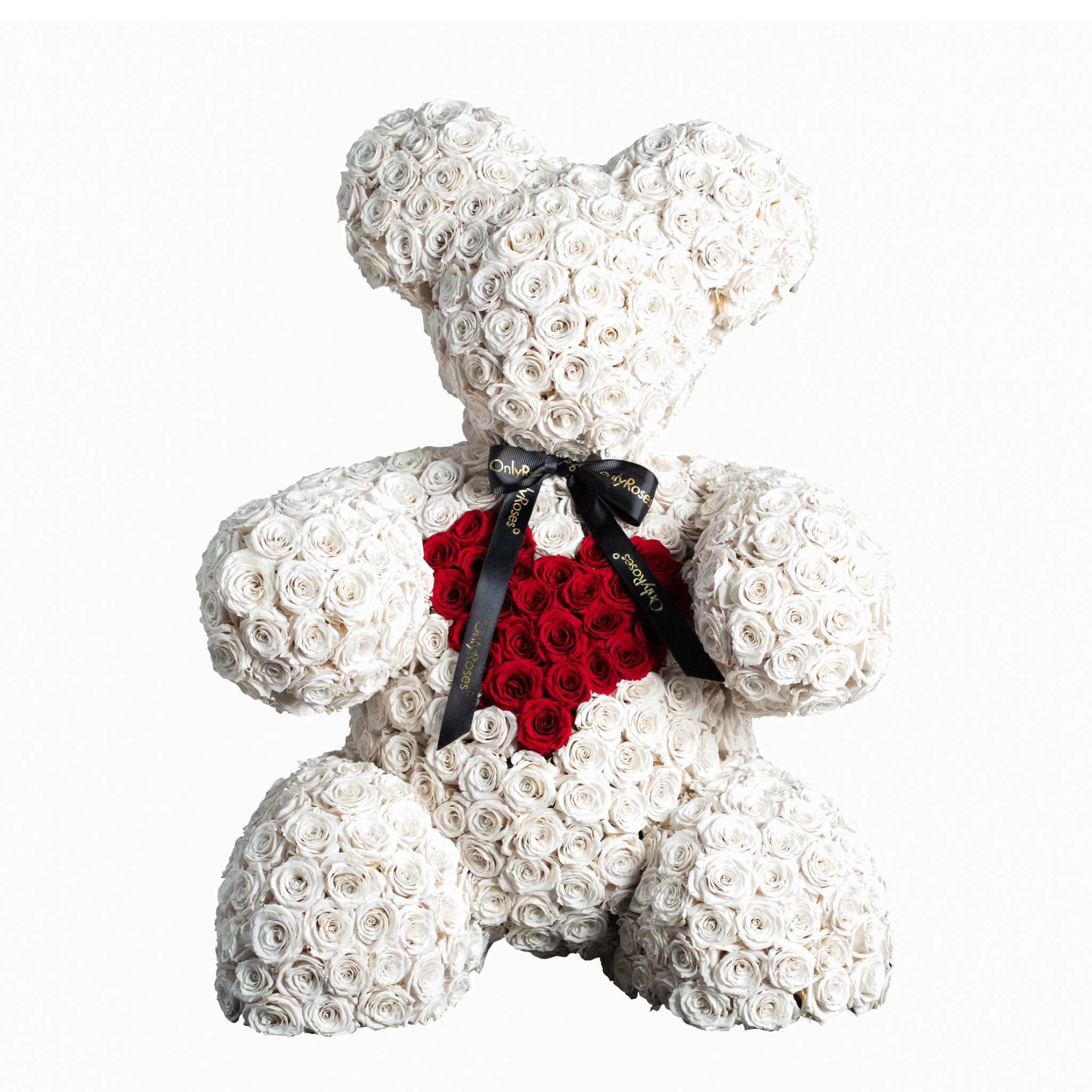 Teddy bear made of white roses with a red heart and black ribbon on a white background
