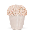 Vase filled with light pink roses on a white background