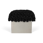 Square box with a black rose arrangement on top against a white background