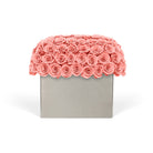 Decorative box with coral pink roses on a white background