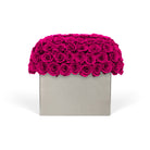 Square gray box with a vibrant pink rose arrangement on a white background