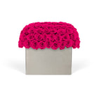 Square gray box with a vibrant pink rose arrangement on a white background