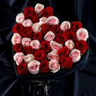 Heart-shaped bouquet of red and pink roses in a box with 'OnlyRoses' branding on a dark background.