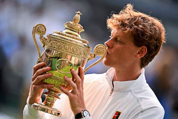 Person holding a golden trophy with a blurred background