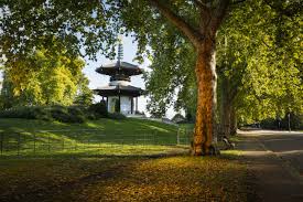 Japanese-style pagoda in a park with trees and greenery