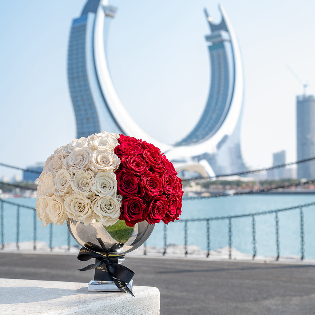 Bouquets of white and red roses in front of a modern architectural background